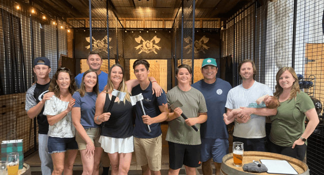 Group of friends posing with axes at Celtic Axe Throwers